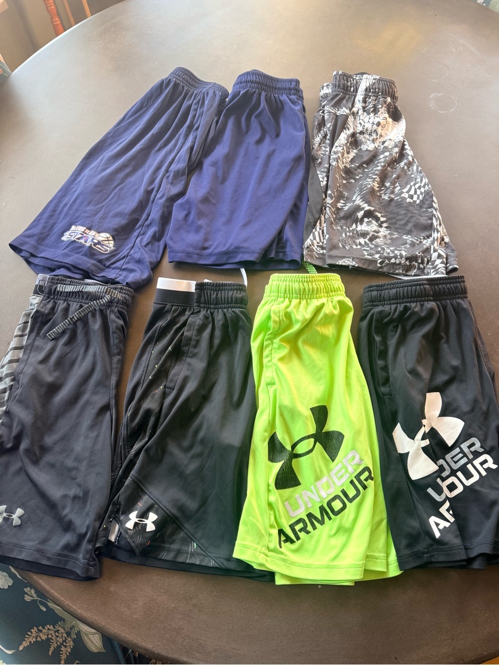7 pairs of Medium youth Shorts — Black, Navy, Neon Green & Gray Camo